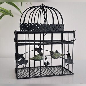 Rectangular wrought iron cage with a domed roof